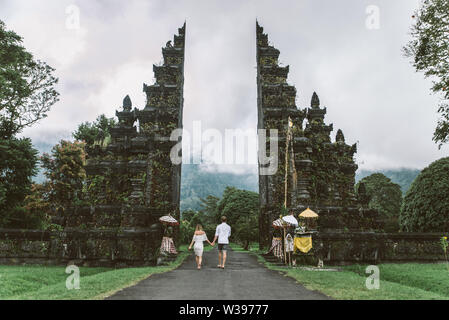 Couple of travelers at Handara Gate in Bali - Indonesia - Two tourists exploring Bali landmarks Stock Photo