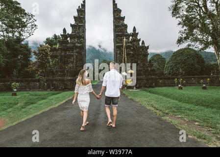 Couple of travelers at Handara Gate in Bali - Indonesia - Two tourists exploring Bali landmarks Stock Photo