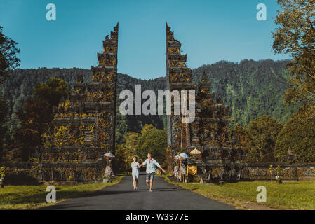 Couple of travelers at Handara Gate in Bali - Indonesia - Two tourists exploring Bali landmarks Stock Photo