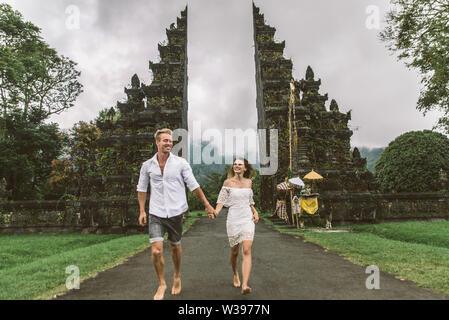 Couple of travelers at Handara Gate in Bali - Indonesia - Two tourists exploring Bali landmarks Stock Photo