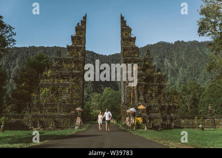 Couple of travelers at Handara Gate in Bali - Indonesia - Two tourists exploring Bali landmarks Stock Photo