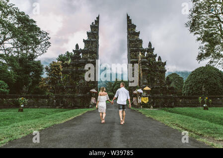 Couple of travelers at Handara Gate in Bali - Indonesia - Two tourists exploring Bali landmarks Stock Photo