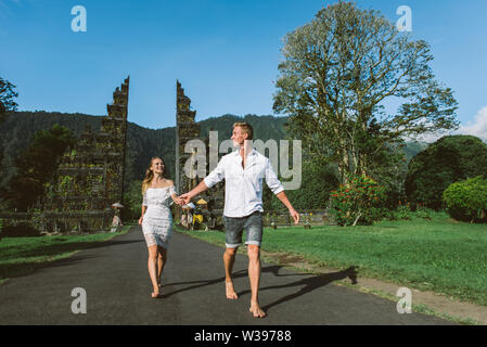 Couple of travelers at Handara Gate in Bali - Indonesia - Two tourists exploring Bali landmarks Stock Photo