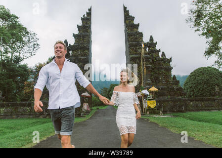 Couple of travelers at Handara Gate in Bali - Indonesia - Two tourists exploring Bali landmarks Stock Photo