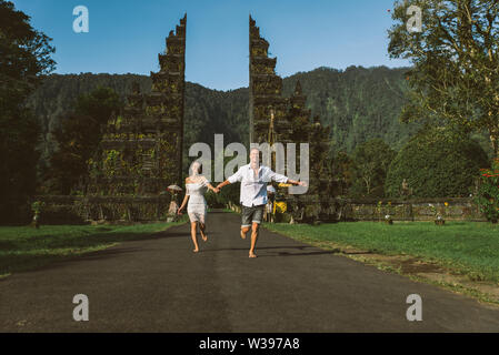 Couple of travelers at Handara Gate in Bali - Indonesia - Two tourists exploring Bali landmarks Stock Photo