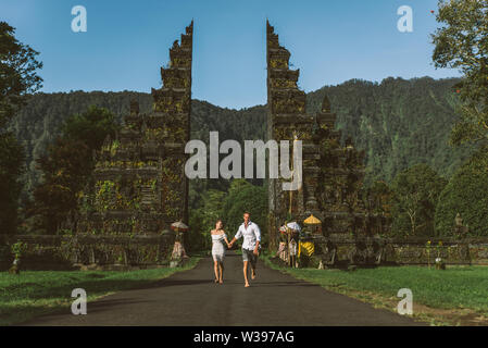 Couple of travelers at Handara Gate in Bali - Indonesia - Two tourists exploring Bali landmarks Stock Photo