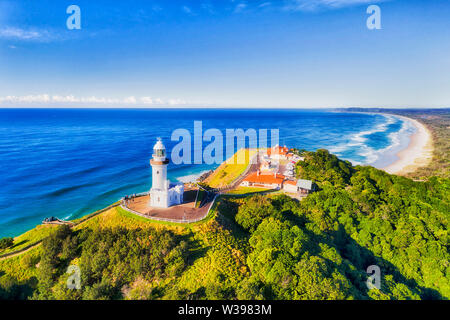 The top of headlands at Byron Bay with famous white lighthouse of the most eastern point of Australian continent overlooking Pacific ocean and wide sa Stock Photo