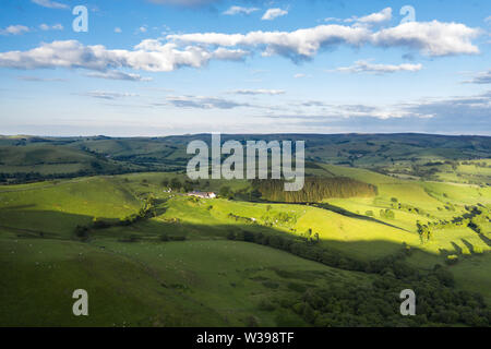 Aerial view over rolling hills of countryside fields in soft warm light. Shropshire in United Kingdom Stock Photo