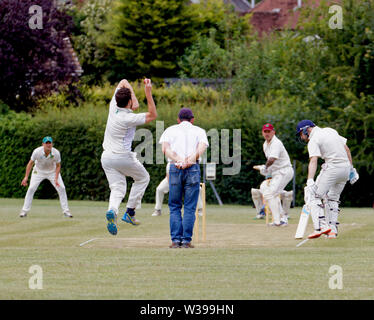 Bowling to a batsman in a village cricket match Stock Photo