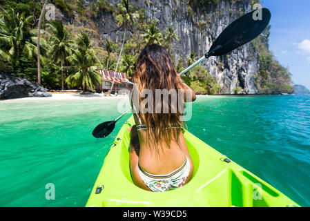 Woman kayaking in the Small Lagoon in Palawan  - El Nido, Palawan, Philippines Stock Photo