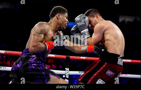 Newark, New Jersey, USA. 14th July, 2019. SHAKUR STEVENSON (black and purple trunks) and ALBERTO GUEVARA battle in a featherweight NABO Title bout at the Prudential Center in Newark, New Jersey. Credit: Joel Plummer/ZUMA Wire/Alamy Live News Stock Photo