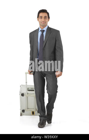 Businessman walking with suitcase Stock Photo