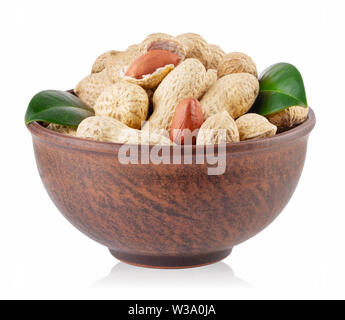 Peanuts with green leaves in a clay plate isolated on white background Stock Photo