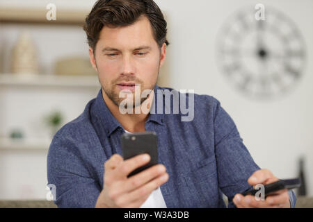 happy man chatting with friends on smartphone Stock Photo