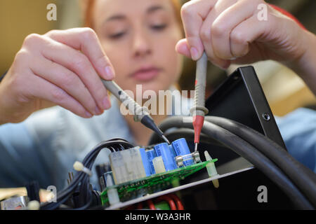 woman working with connected cables Stock Photo