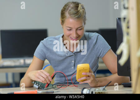 female technician using probe in electrical system Stock Photo