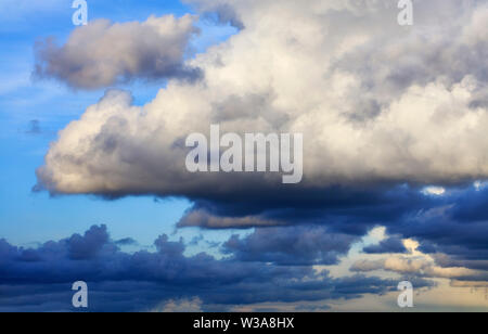 Thunderclouds float in the sky, gathering together. Stock Photo