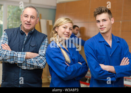 carpenter with students in workshop Stock Photo
