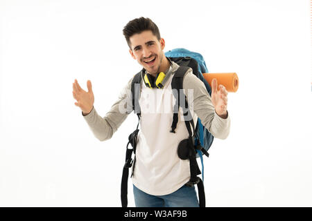 Portrait of happy cool latin man with backpack isolated on white background. In traveling the world, youth and living the dream, holidays student exch Stock Photo