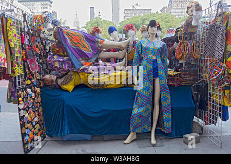 Women's clothing with Senegalese designs for sale at a booth set up on East 14th St. near Union Square Park in lower Manhattan, New York City. Stock Photo