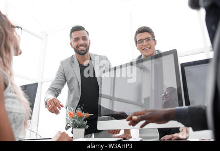 young employees giving each other high five Stock Photo