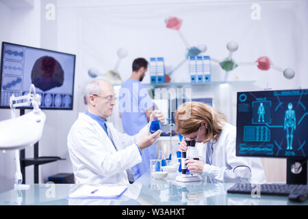 Groupe of researchers in pharmacology in a hospital laboratory. Modern equipment in research laboratory. Stock Photo