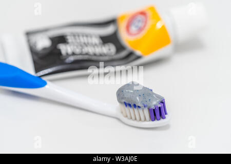 Closeup of a charcoal whitening toothpaste on a toothbrush Stock Photo
