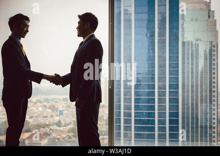 Two business partners shaking hands Stock Photo