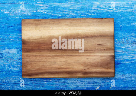 Rectangular wooden cutting board made of light wood as a background - space for text. on brown wooden background Stock Photo