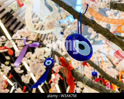 The evil eye Hamsa, a charm made to ward off the evil eye and protect the person wearing it. Traditional Muslim decoration in Turkey and Greece. Stock Photo