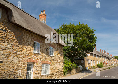 A view of thatched houses in the village of Abbotsbury near Chesil Beach. Dorset England UK GB Stock Photo