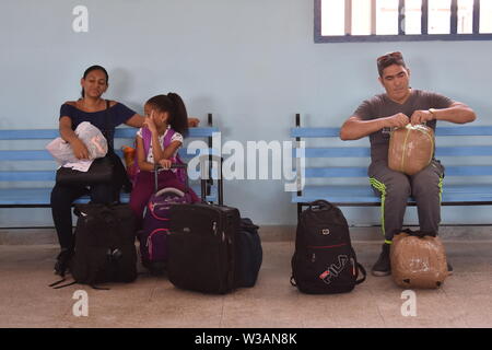 (190714) -- HAVANA, July 14, 2019 (Xinhua) -- Passengers wait to board the train at Havana Central Railway Station in Havana, capital of Cuba, July 13, 2019. The first train made up entirely by Chinese wagons began a 14-hour, 835-km journey between Havana and Santiago de Cuba, the second-largest city on the island. This convoy has 12 wagons recently arriving from China, the first of four convoys to start rolling in the coming days as part of an ambitious program to update the Cuban railway system. TO GO WITH 'Feature: With Chinese trains rolling, Cuba starts revamping railway system' (Xinh