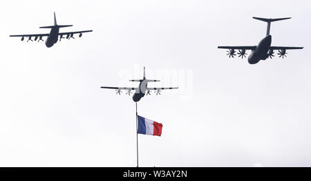 Paris, France. 14th July, 2019. French military aircrafts fly over the Pyramid of Louvre Museum during the annual Bastille Day military parade in Paris, France, on July 14, 2019. Credit: Gao Jing/Xinhua/Alamy Live News Stock Photo