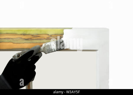 Close up of a person painting restored sash windows. Sash window restoration. Stock Photo
