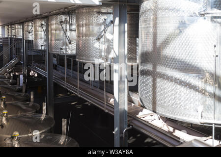 huge industrial or commercial stainless steel vats or tanks in a winery cellar in Stellenbosch, Cape Winelands, South Africa Stock Photo