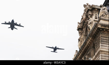 Paris, France. 14th July, 2019. French military aircrafts fly over the Pyramid of Louvre Museum during the annual Bastille Day military parade in Paris, France, on July 14, 2019. Credit: Gao Jing/Xinhua/Alamy Live News Stock Photo