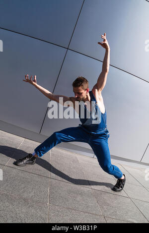 Young contemporary dancer man on grey background Stock Photo