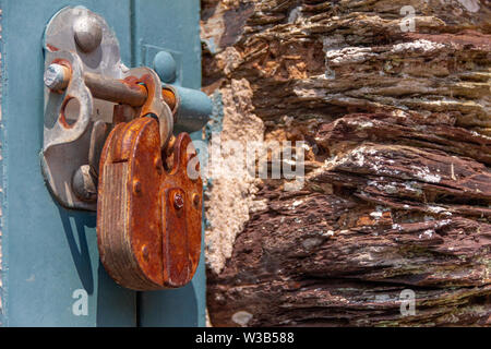 Rusty old metal lock on blue barn door Stock Photo