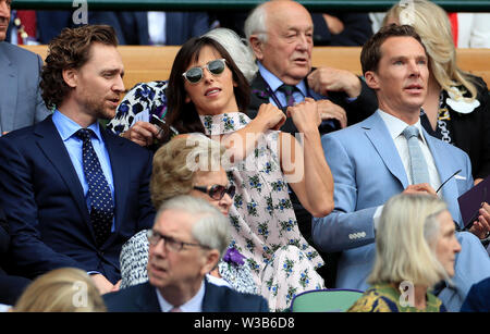 Tom Hiddleston, Sophie Hunter and Benedict Cumberbatch on day thirteen of the Wimbledon Championships at the All England Lawn tennis and Croquet Club, Wimbledon. Stock Photo
