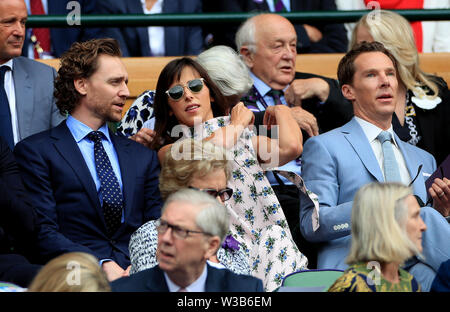 Tom Hiddleston, Sophie Hunter and Benedict Cumberbatch on day thirteen of the Wimbledon Championships at the All England Lawn tennis and Croquet Club, Wimbledon. Stock Photo