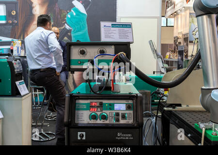 BUDAPEST/HUNGARY - 05.18, 2019: A pulse welder robot on display at a booth in an industry and technology trade show. Control panel in foreground. Stock Photo