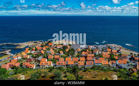 07 July 2019, Denmark, Gudhjem: City view of Gudhjem, a small town on the north coast of the Danish Baltic Sea island Bornholm (aerial view with a drone). The island Bornholm is, together with the offshore archipelago Ertholmene, Denmark's most eastern island. Thanks to its location, the island of Bornholm counts many hours of sunshine. Photo: Patrick Pleul/dpa-Zentralbild/ZB Stock Photo