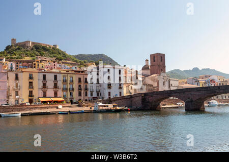 View of Bosa, Sardinia, with colorful Italian houses and castle on hilltop. River Temo with bridge in foreground. Summer day shot. Stock Photo