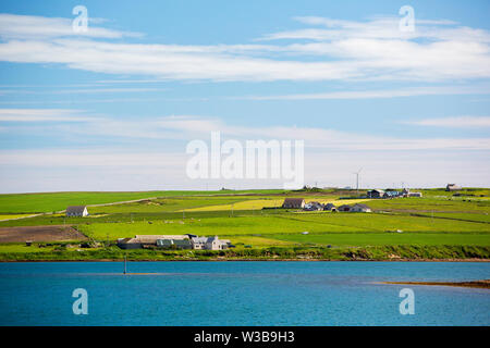 Farmland on South Ronaldsay in the Orkneys, Scotland, UK with small scale wind turbines. Stock Photo