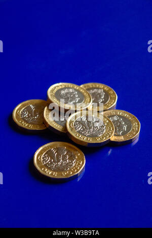 One pound coins with blue background Stock Photo