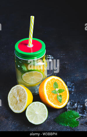 Jar of cool, fresh lemonade made from lemon, lime, orange and mint. Stock Photo