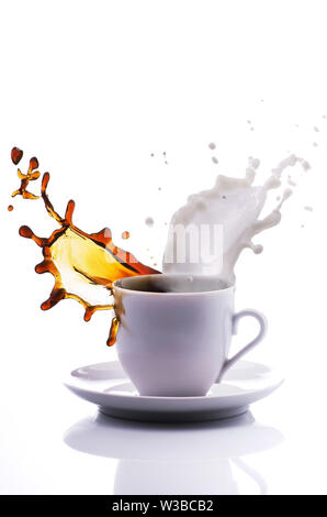A lively cup of coffee and milk with splash isolated on white background Stock Photo