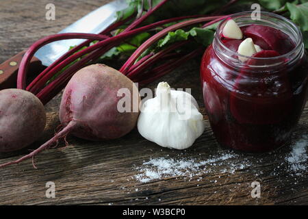 Pickled beets in the jar on a dark wood background Stock Photo