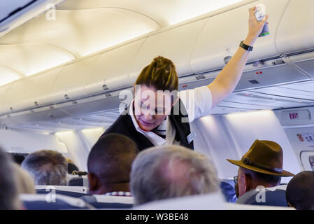 British Airways (operated by Comair) cabin crew sprays an insecticide inside the cabin before take-off as a precaution.  Namibia Stock Photo