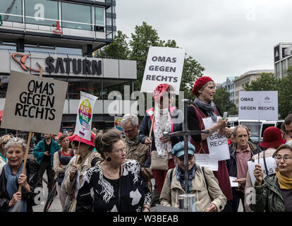 Berlin, Germany. 14th July, 2019. 'Grandma against right' is written on signs of demonstrators protesting against a 'right-wing' demonstration on Breitscheidplatz. Credit: Paul Zinken/dpa/Alamy Live News Stock Photo